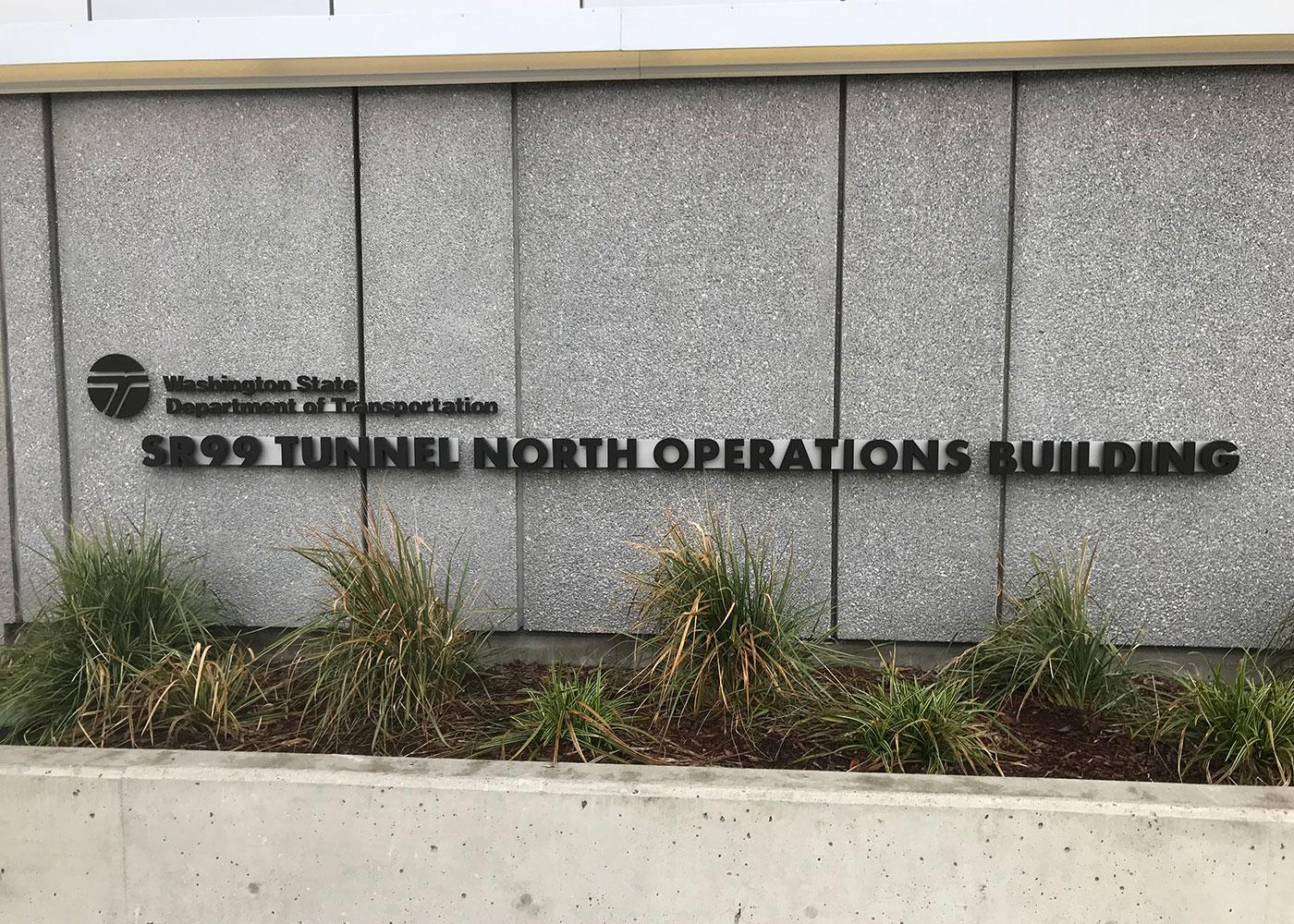 North and South Operations Buildings received cast aluminum letters and the WSDOT logo finished with dark bronze anodized effect mounted to an aluminum bar flush to the building.