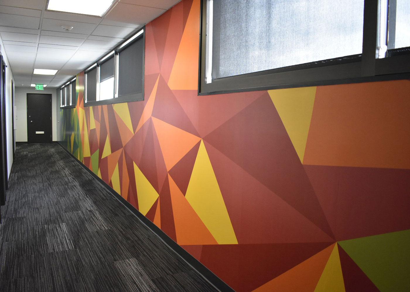 Multiple buildings received interior vinyl wall graphics in common space areas and long hallways featuring a variety of floor-to-ceiling designs.